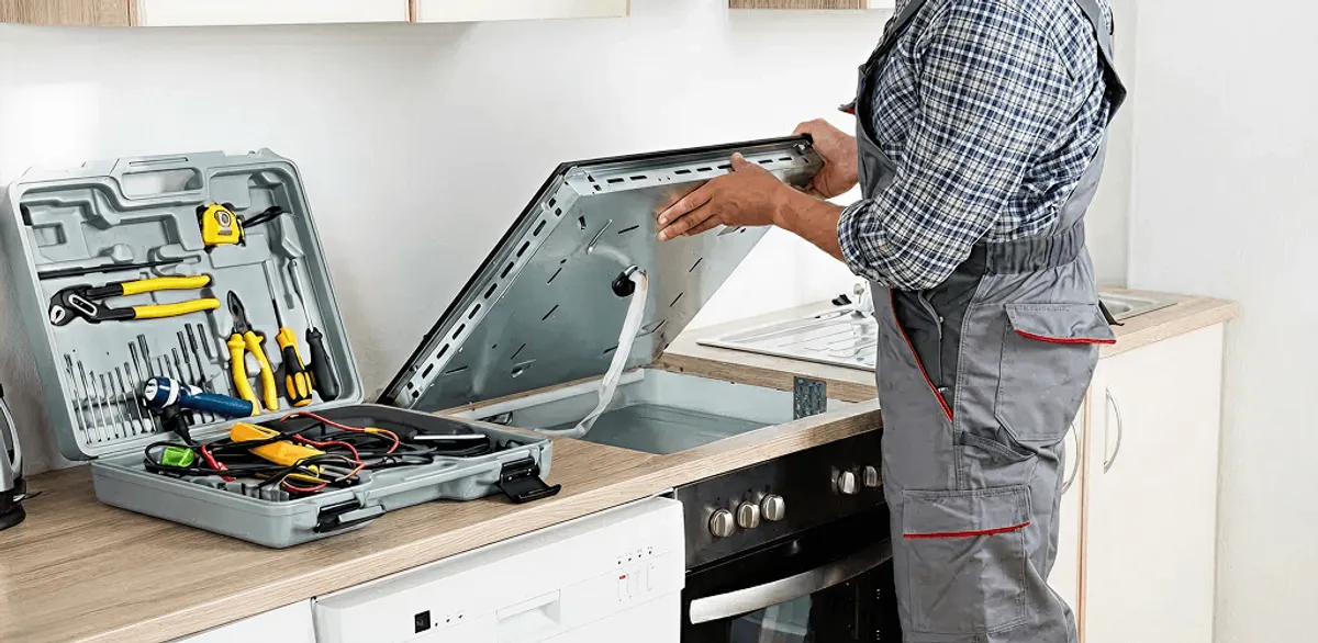 Handyman repairing a cooktop and checking wiring connections in Shreveport, LA