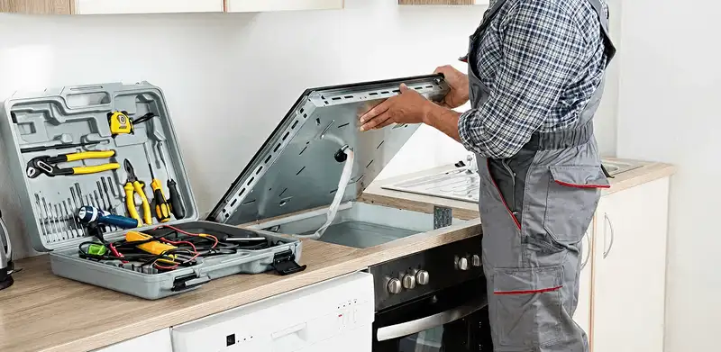 Handyman repairing a cooktop and checking wiring connections in Shreveport, LA