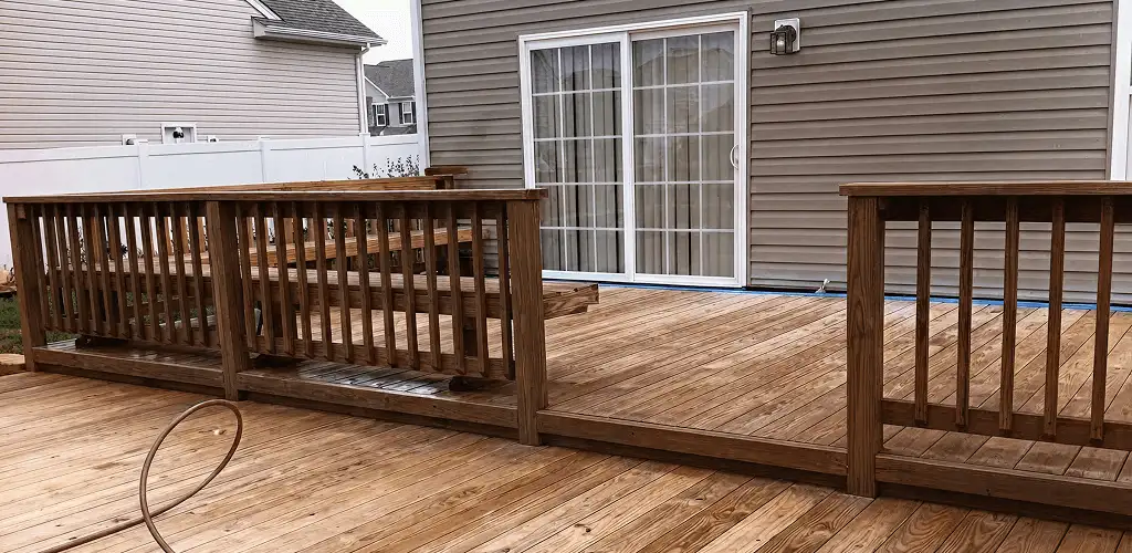 Deck sealing service protecting a backyard wood deck and railings in Shreveport, LA