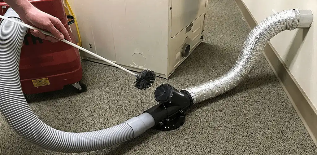 Dryer vent cleaning service removing lint from a dryer duct connection in Shreveport, LA