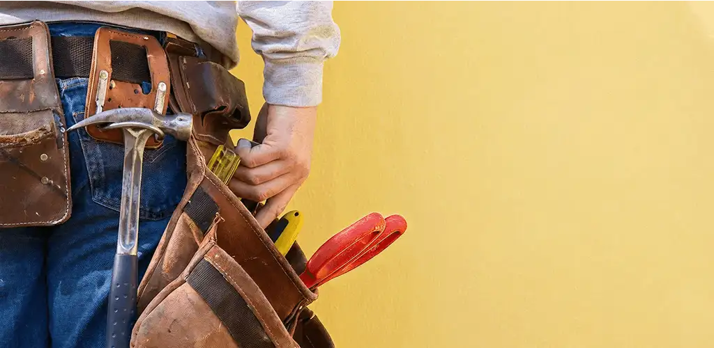 Handyman with tool belt ready for home repairs and maintenance in Shreveport, LA