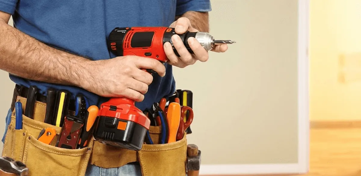 Handyman holding a power drill for home repairs and installations in Shreveport, LA