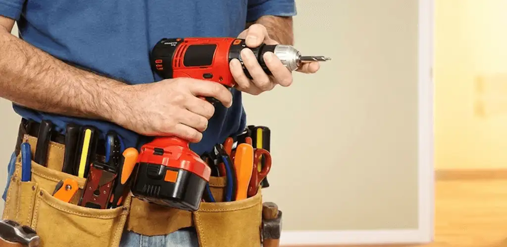 Handyman holding a power drill for home repairs and installations in Shreveport, LA