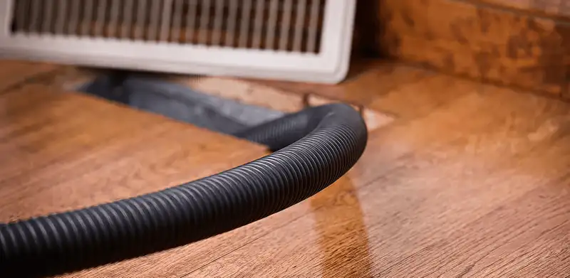 Air duct cleaning hose inserted into a floor vent for ductwork cleaning in Shreveport, LA