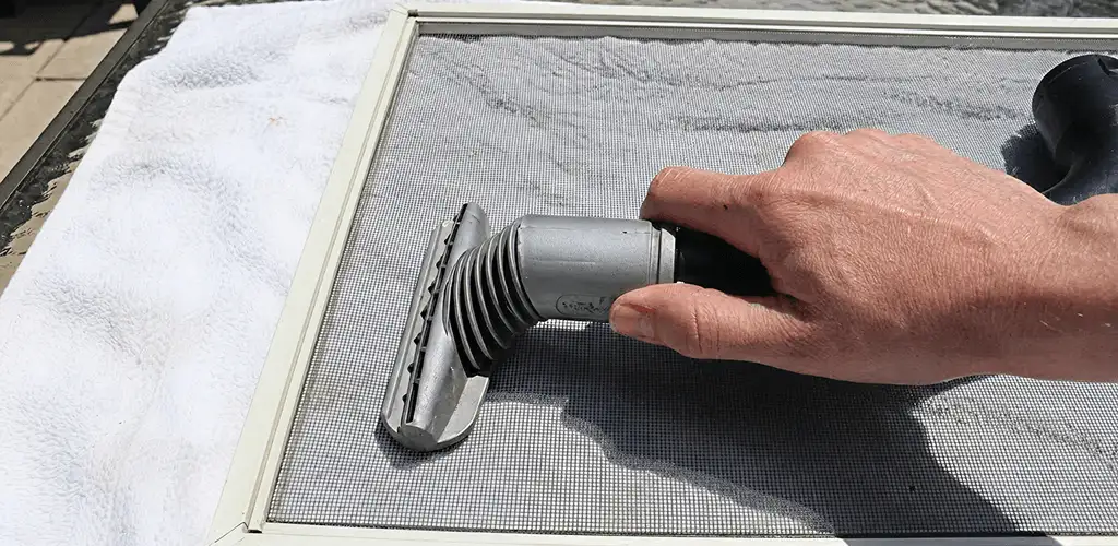 Window screen repair cleaning and fixing a damaged screen mesh in Shreveport, LA
